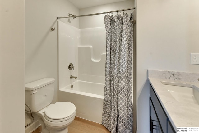 full bathroom with hardwood / wood-style floors, vanity, toilet, and shower / bath combo