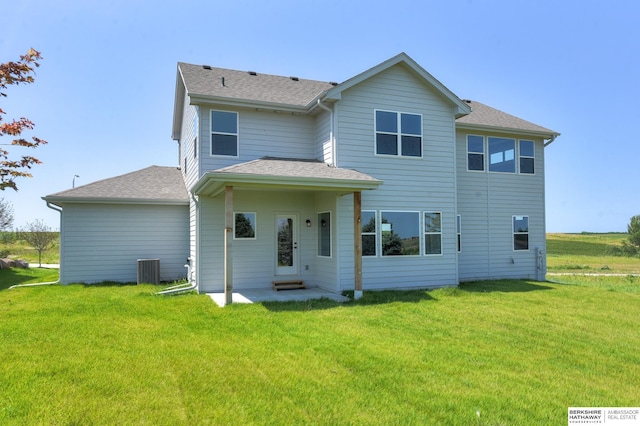 back of house with a yard and cooling unit