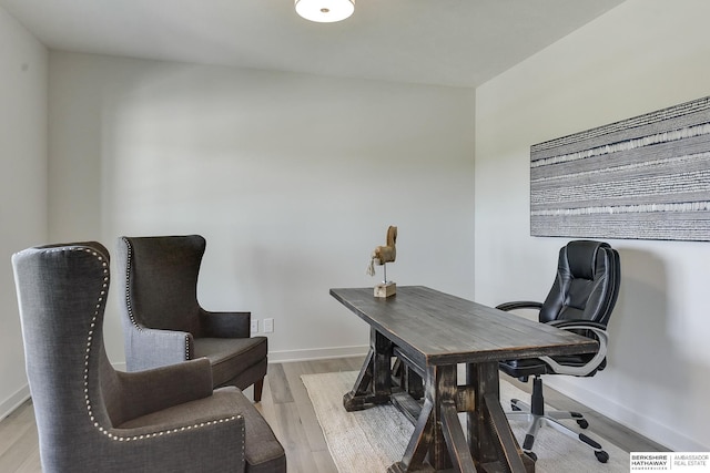 home office with light hardwood / wood-style flooring