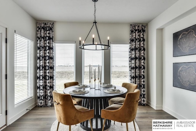 dining space featuring hardwood / wood-style floors and a notable chandelier