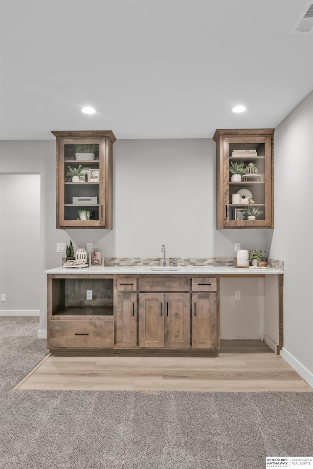 bar with light colored carpet and sink