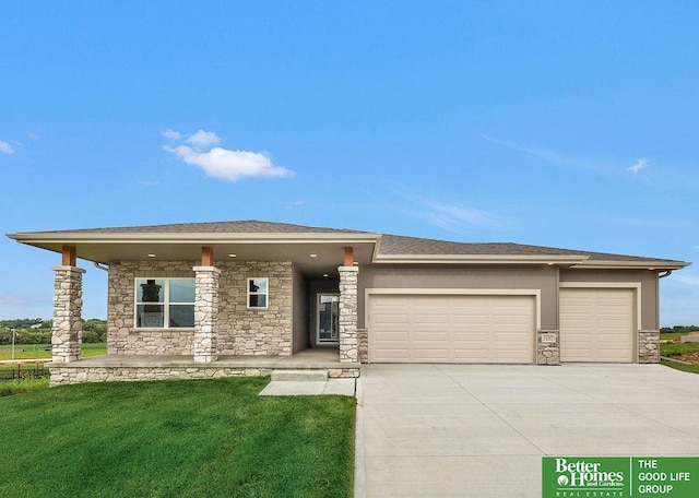 prairie-style house with a garage and a front lawn