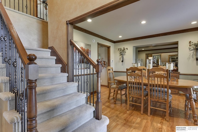 dining room featuring light wood-type flooring and crown molding