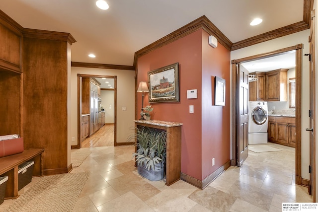 hall featuring washer / clothes dryer and crown molding