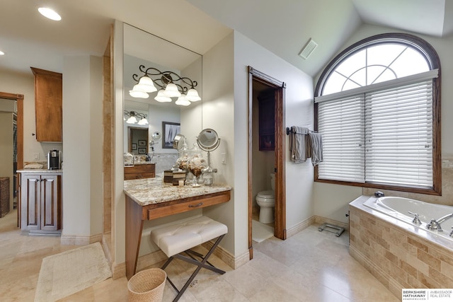 bathroom with vanity, lofted ceiling, tile patterned floors, a relaxing tiled tub, and toilet