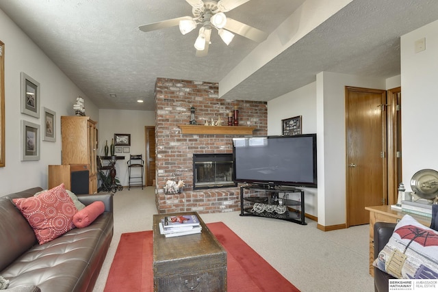 living room featuring a textured ceiling, light colored carpet, a brick fireplace, and ceiling fan