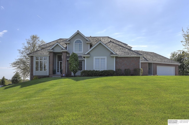 view of front of property with a front lawn and a garage