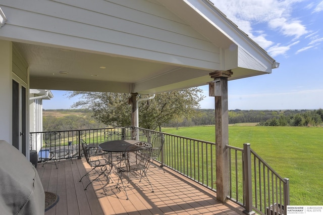 wooden terrace with a yard