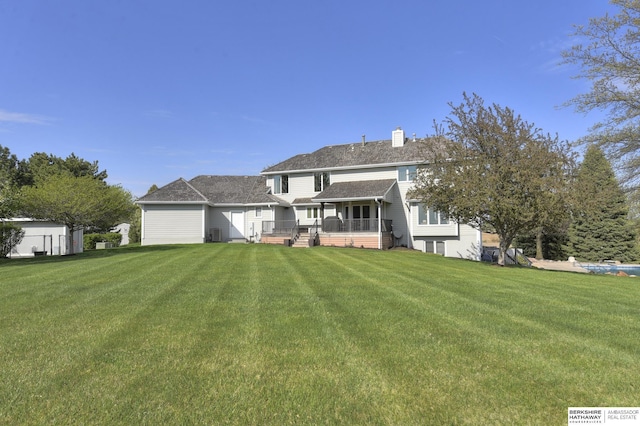 rear view of house with a lawn