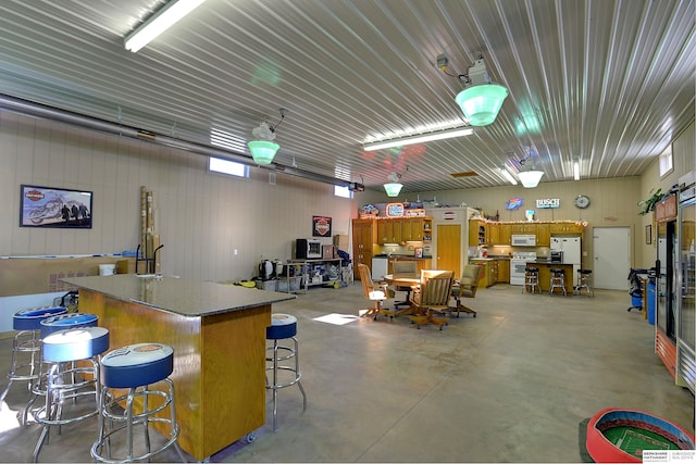 garage with white refrigerator with ice dispenser