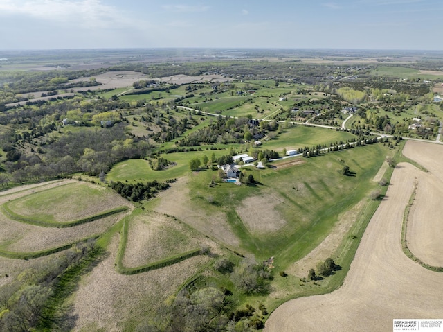 birds eye view of property with a rural view