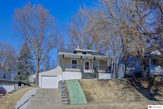 view of front of property with a porch, a garage, and an outdoor structure