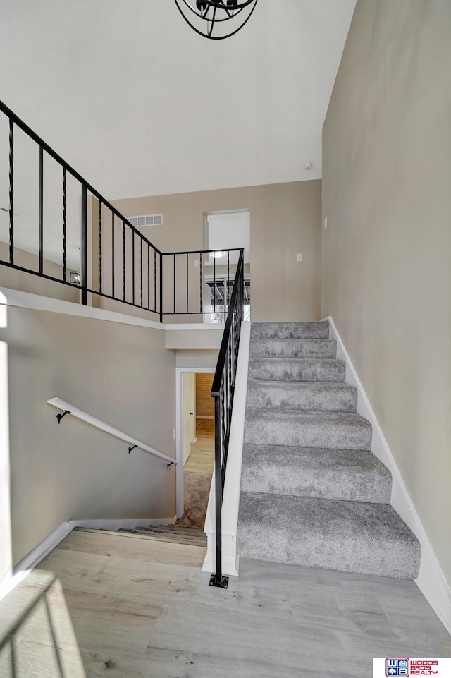 stairs featuring hardwood / wood-style floors