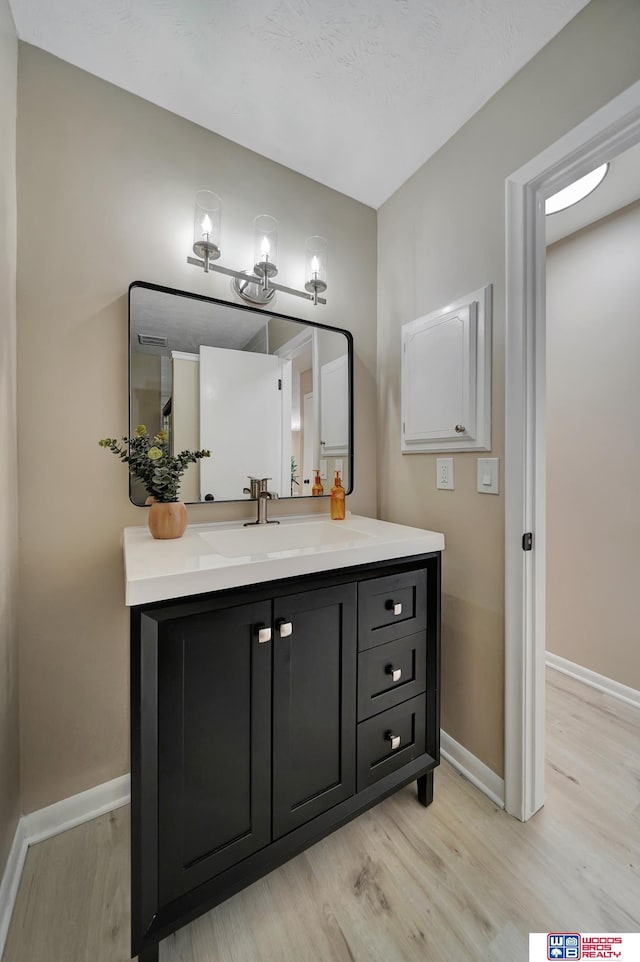 bathroom featuring wood-type flooring and vanity