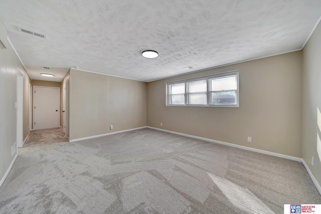 carpeted spare room featuring a textured ceiling