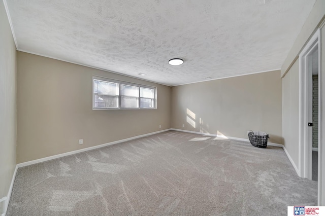 spare room with a textured ceiling and light carpet