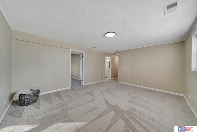 carpeted spare room with a textured ceiling