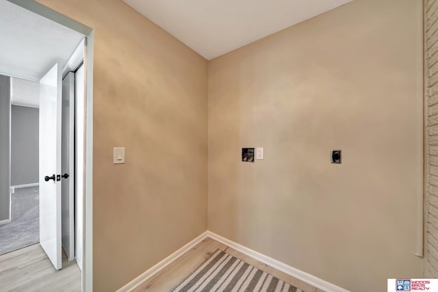 clothes washing area with hookup for an electric dryer and light hardwood / wood-style flooring