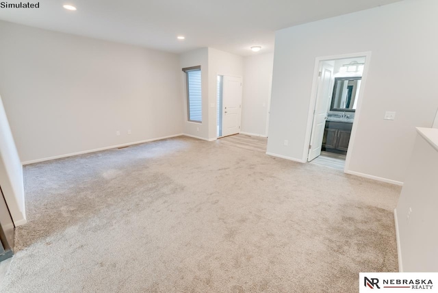 unfurnished living room with light colored carpet