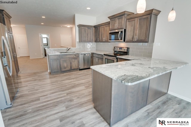 kitchen with kitchen peninsula, backsplash, light stone counters, stainless steel appliances, and pendant lighting