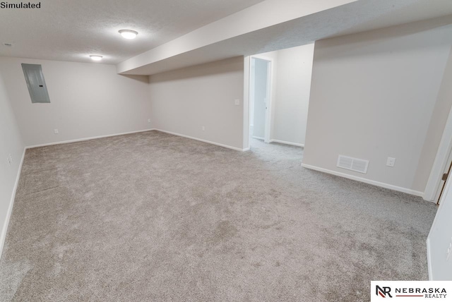 basement featuring carpet flooring, electric panel, and a textured ceiling