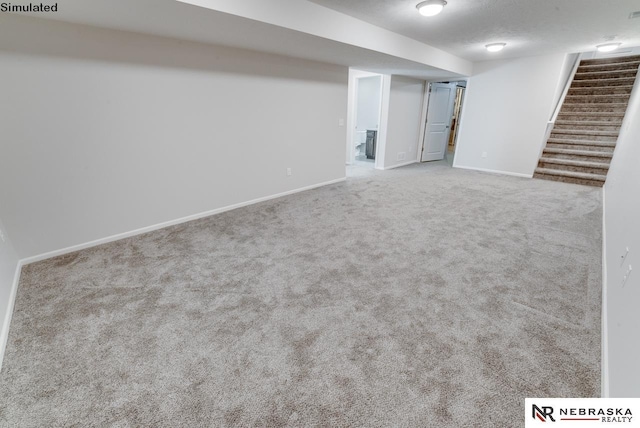 basement featuring carpet floors and a textured ceiling