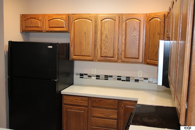 kitchen with black refrigerator and electric stove