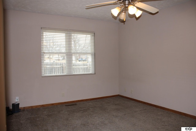 empty room featuring ceiling fan, a textured ceiling, and carpet