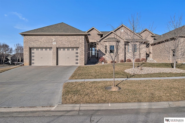 view of front of house featuring a front lawn and a garage