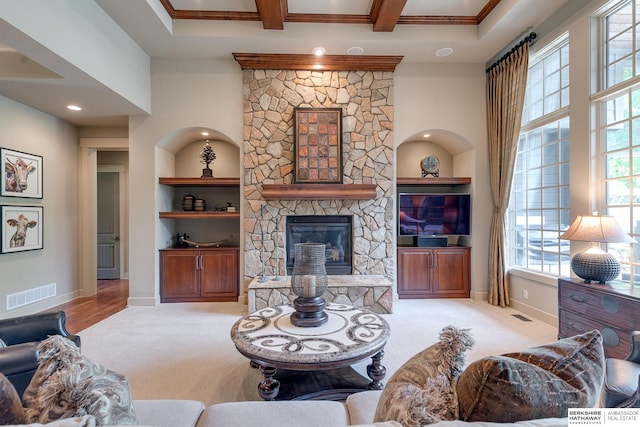 carpeted living room with a fireplace and built in shelves