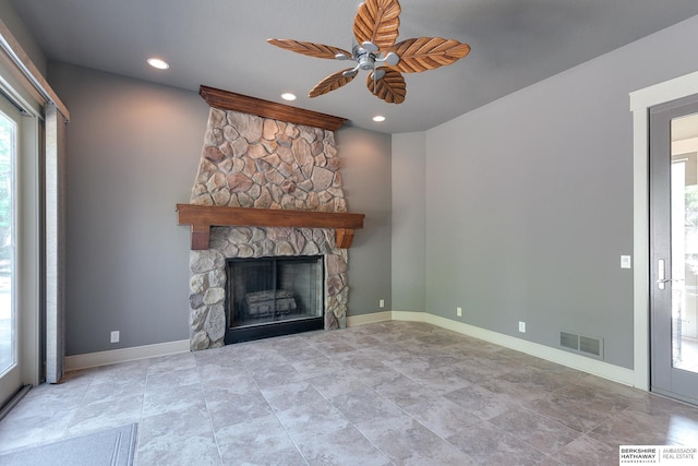 unfurnished living room with a fireplace and ceiling fan