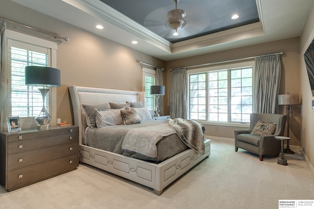 bedroom with ceiling fan, a raised ceiling, ornamental molding, and light carpet