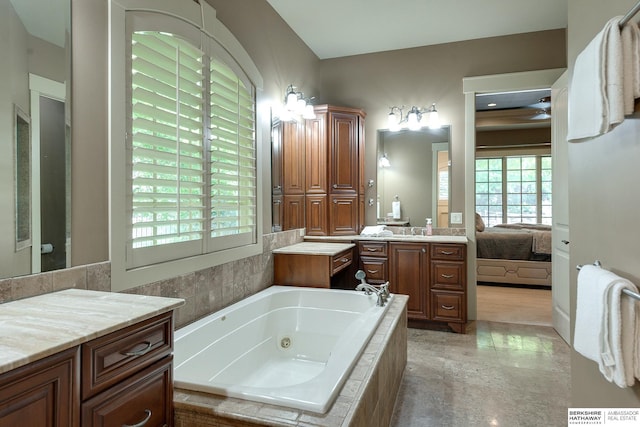 bathroom with vanity and tiled tub