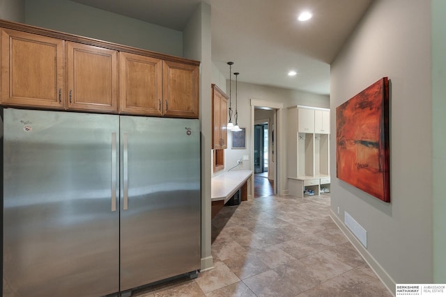 kitchen featuring stainless steel refrigerator and hanging light fixtures