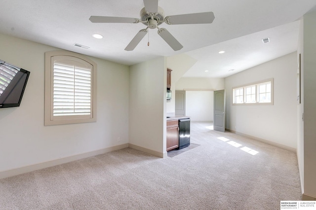 empty room featuring light carpet and ceiling fan