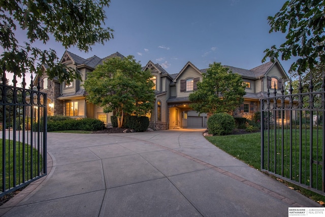 view of front of house featuring a garage and a lawn