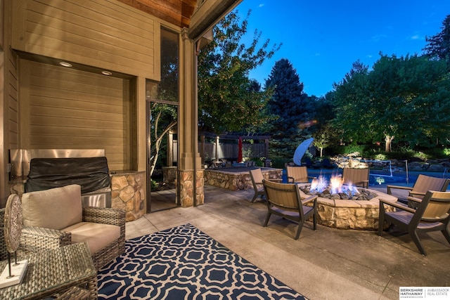 view of patio featuring an outdoor living space with a fire pit