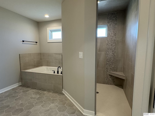 bathroom with tile patterned floors and independent shower and bath