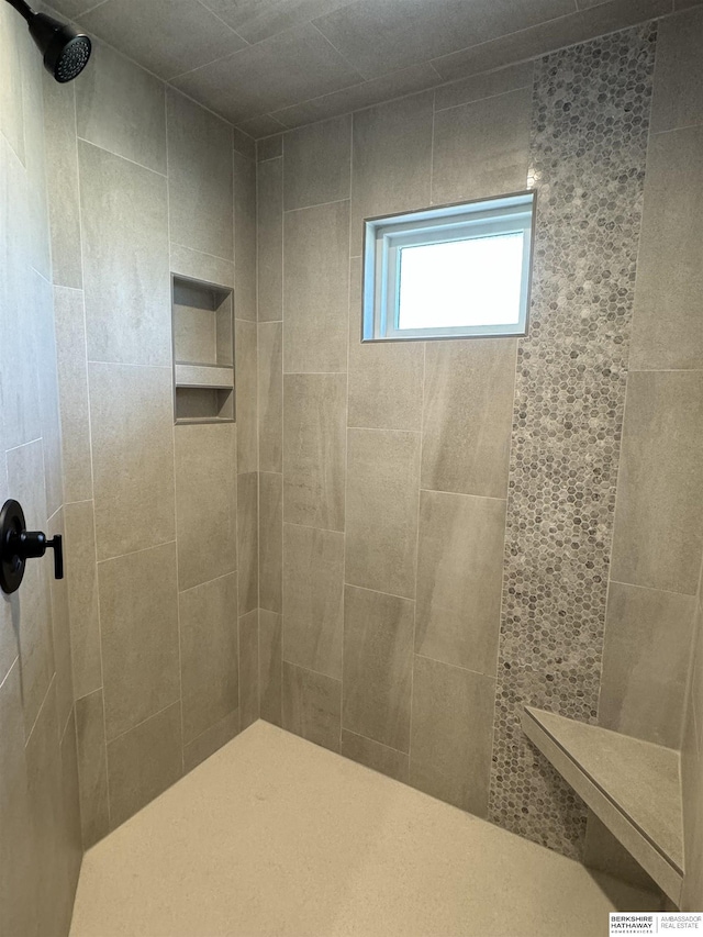 bathroom with a tile shower