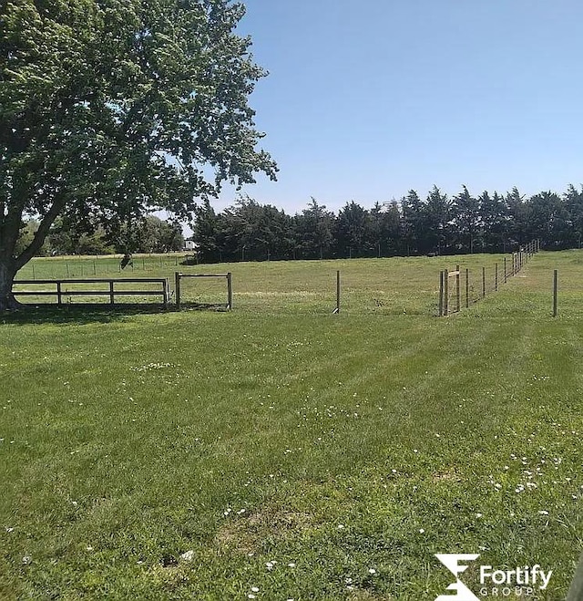 view of yard with a rural view