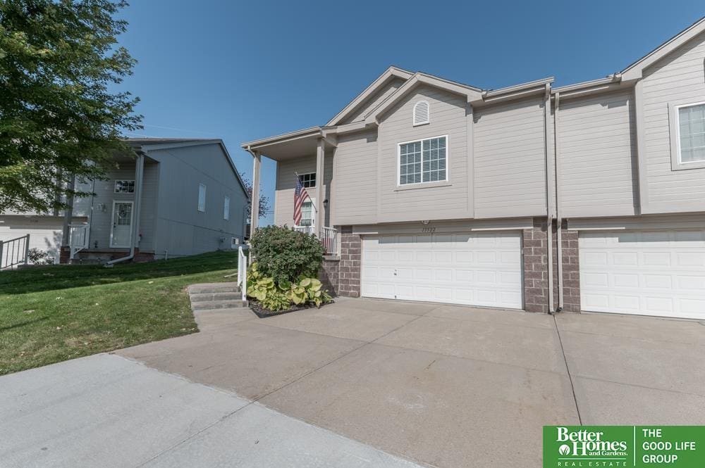 view of front of property with a garage and a front lawn