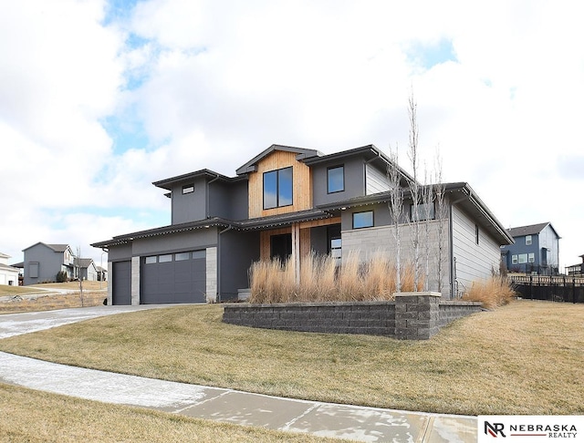 view of front of home featuring a garage, concrete driveway, a front lawn, and stucco siding