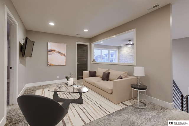 living room with light carpet and ceiling fan