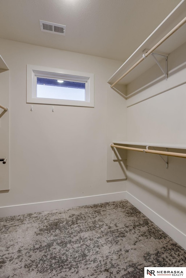 spacious closet with carpet floors and visible vents