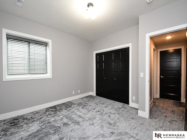 unfurnished bedroom with carpet floors and a closet