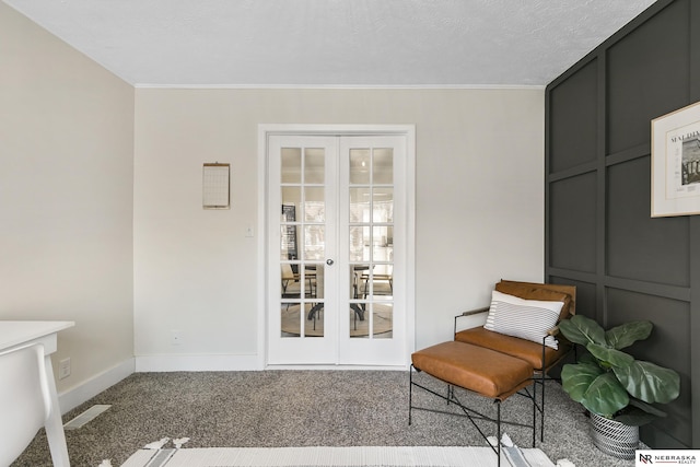 living area featuring french doors, a textured ceiling, carpet, and crown molding