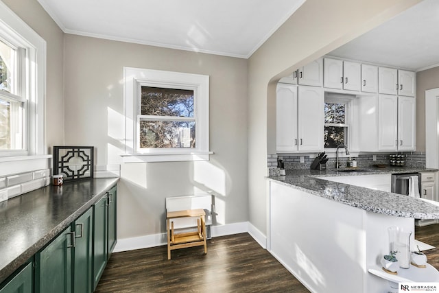 kitchen with sink, green cabinets, white cabinets, tasteful backsplash, and crown molding