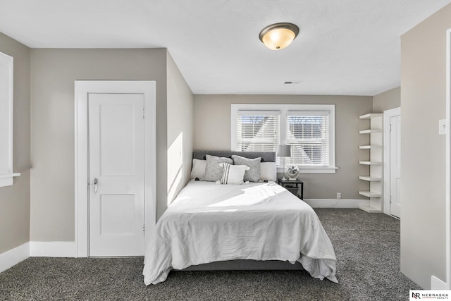 bedroom featuring dark colored carpet