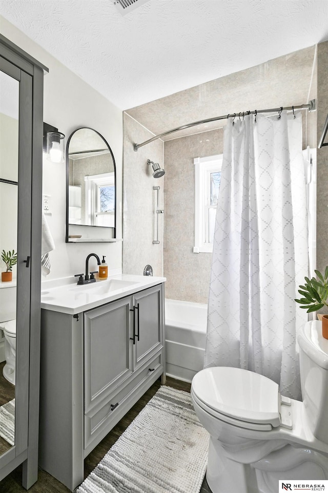 full bathroom featuring shower / bathtub combination with curtain, a wealth of natural light, and toilet