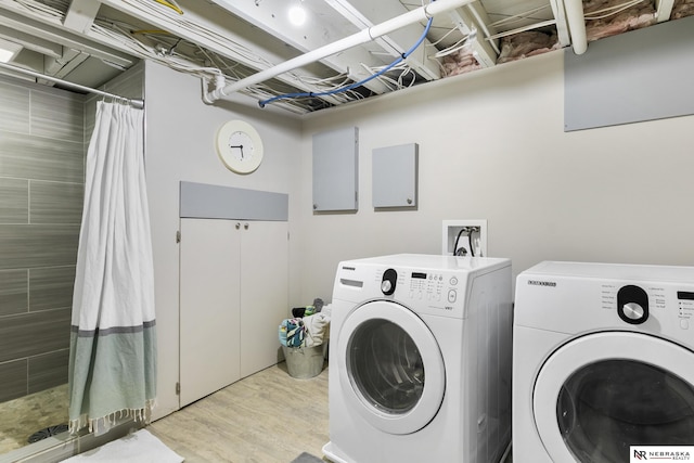 washroom featuring light hardwood / wood-style floors and washer and clothes dryer